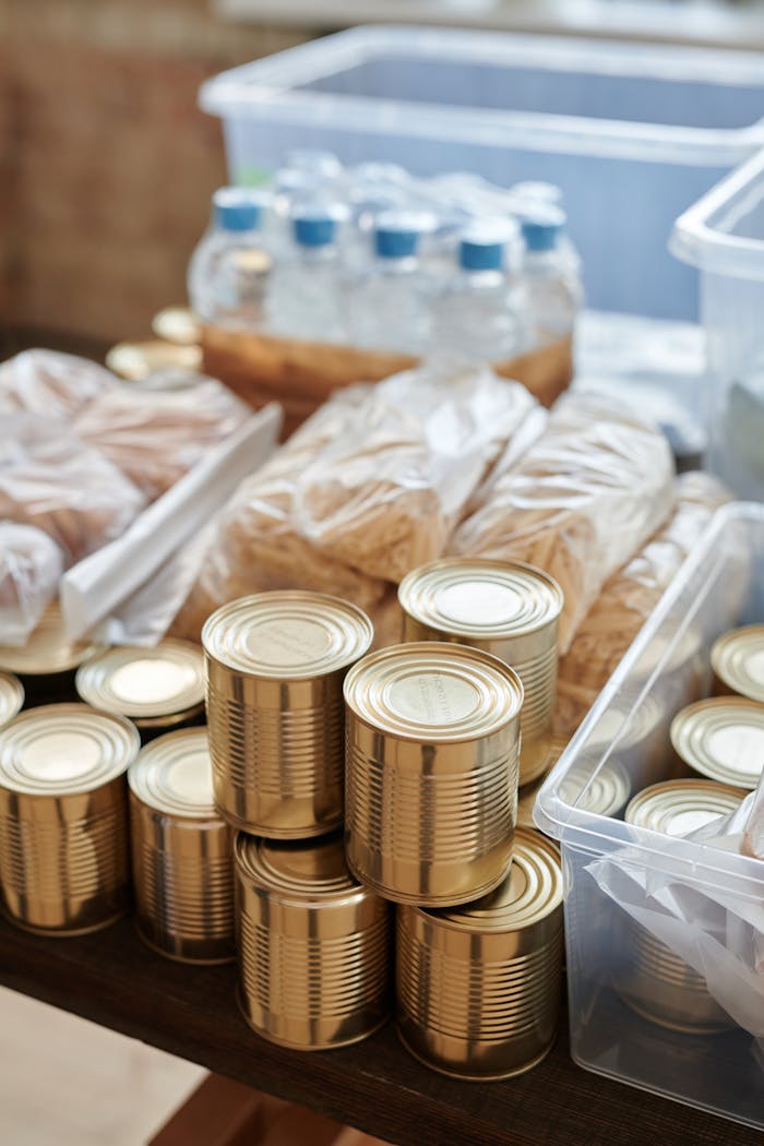 hero-services A variety of canned goods and packaged items arranged for a donation drive or food bank collection.